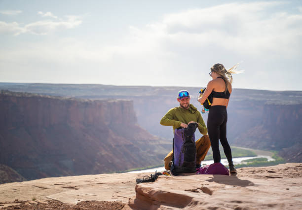 istock Young couple hiking in Moab park, Utah at sunset 1400368510