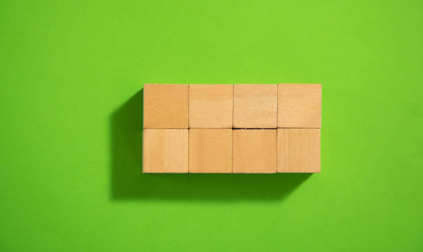 istock Empty wooden cubes on the green background. 1400370231