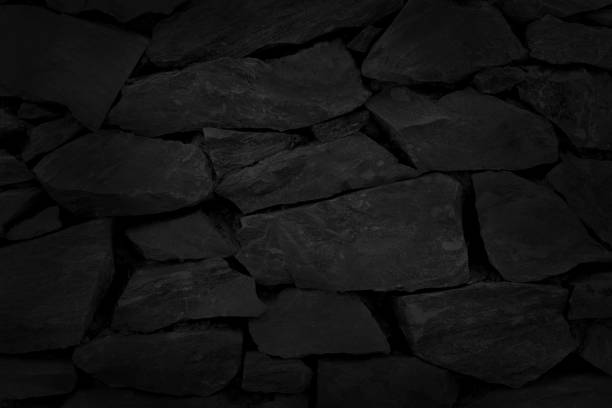 istock Black stone brick wall texture in natural pattern for background and design art work. 1400370299