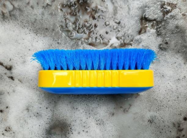 Cleaning Brush - dirty and dusty detergent foam background.