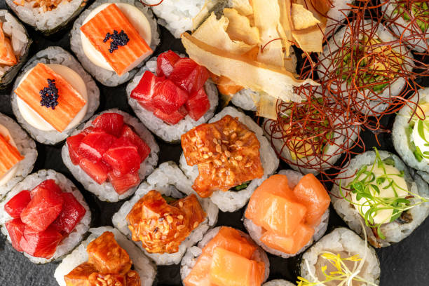 istock Sushi set of various products on a black stone plate 1400372533