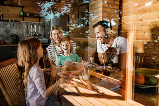 istock Young happy family enjoying in their breakfast at dining table. 1400374422