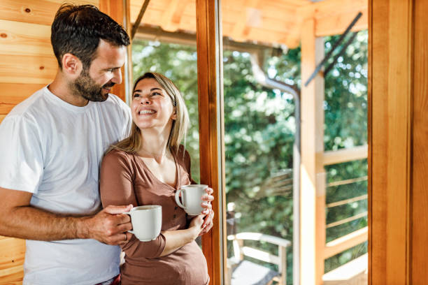 istock Young happy couple talking during morning coffee at home. 1400374474