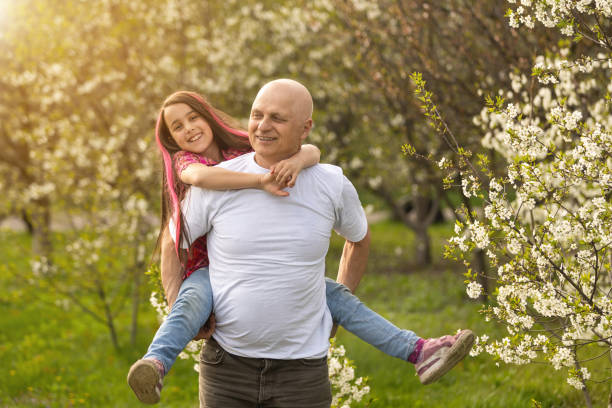 istock grandfather and granddaughter in backyard 1400375077