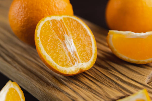 istock Sliced oranges fruit on wooden board. Orange juicy fruit, citrus minimal concept 1400375201
