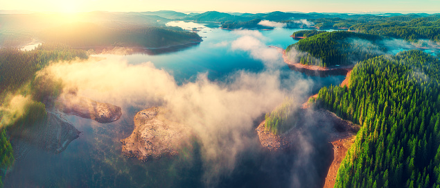 Aerial view of morning fog on the lake, sunrise shot.