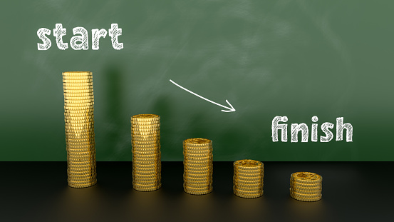 Money reduction concept image. Stacks of coins in a decrease financial concept. the words start and finish with an arrow are written in chalk on a slate blackboard. 3d illustration