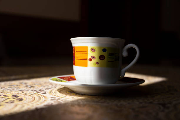 around a cup coffee beans lie