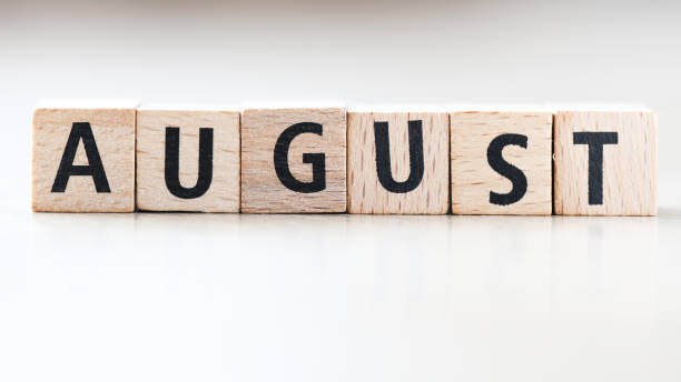 istock AUGUST word arranged from wooden letters on a light background. 1400377180