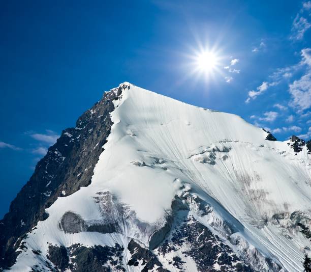 istock top of mountain in a rays of sun 1400377399