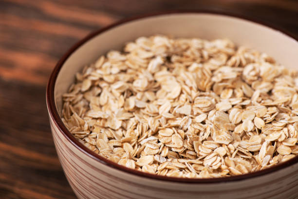 istock Bowl with oatmeal flakes on a wooden background 1400378026