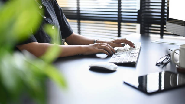 istock Cropped shot woman hands typing on wireless keyboard while working in modern office. 1400379458