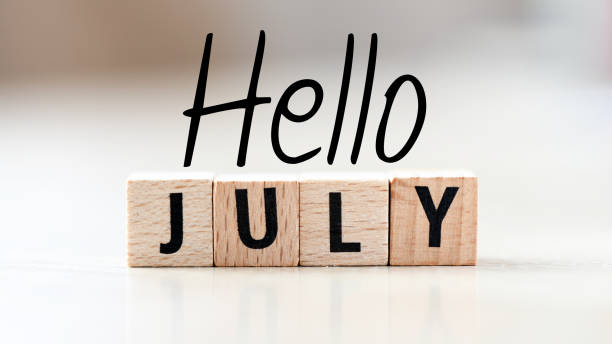 istock HELLO JULY word on a small chalk board on a light background. 1400379472