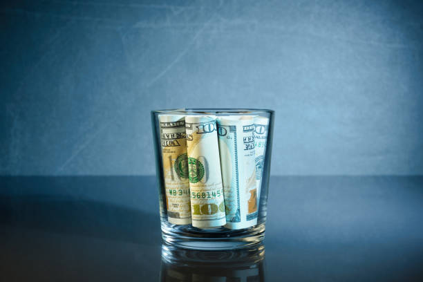 istock USD banknotes in glass over blue background with copy space 1400379573