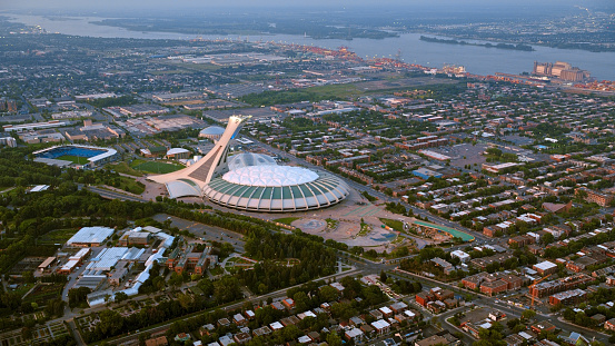 Montreal, CA / USA - August 07, 2019: Aerial view of Olympic Stadium in Montreal, Quebec, Canada.\n\nOlympic Stadium is a multi-purpose stadium in Montreal, Canada, located at Olympic Park in the Hochelaga-Maisonneuve district of the city. Montreal Olympic Stadium was built in the 1970s to serve as the flagship venue of the 1976 Summer Olympics.