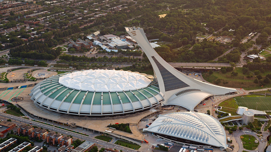 Montreal, CA / USA - August 07, 2019: Aerial view of Olympic Stadium in Montreal, Quebec, Canada.\n\nOlympic Stadium is a multi-purpose stadium in Montreal, Canada, located at Olympic Park in the Hochelaga-Maisonneuve district of the city. Montreal Olympic Stadium was built in the 1970s to serve as the flagship venue of the 1976 Summer Olympics.