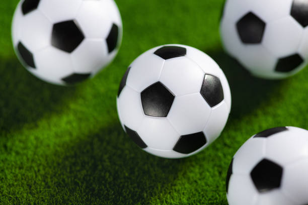 istock Several soccer balls on a green grass field. 1400380505