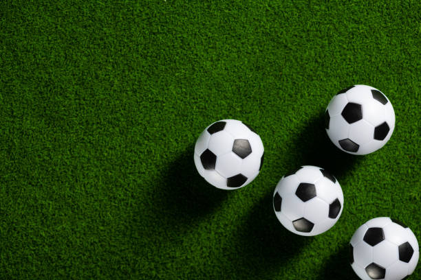 istock Several soccer balls on a green grass field. 1400380524