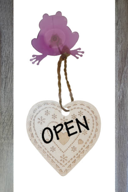istock Open panel suspended and fixed to a window by a suction cup in the shape of a frog  Decoration store Message written in English 1400380559