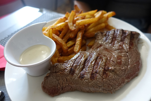Grilled steak a la plancha served with a Roquefort sauce and fried potatoes