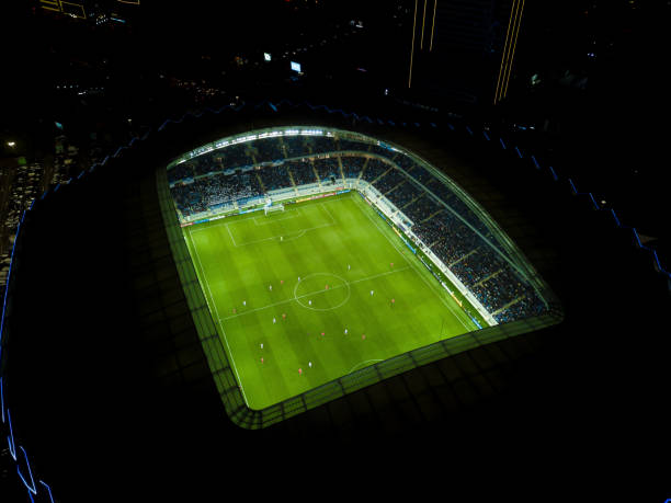 imagen de un dron del nuevo estadio en batumi. vista nocturna desde un dron en un campo de fútbol con jugadores durante un partido - georgia football fotografías e imágenes de stock