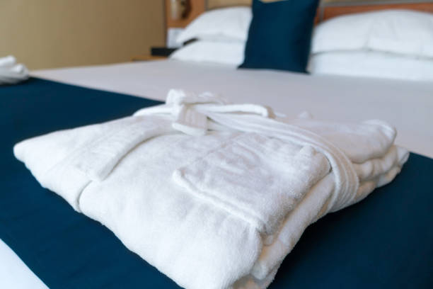 istock Close-up of a folded white terry robe on the bed 1400384058