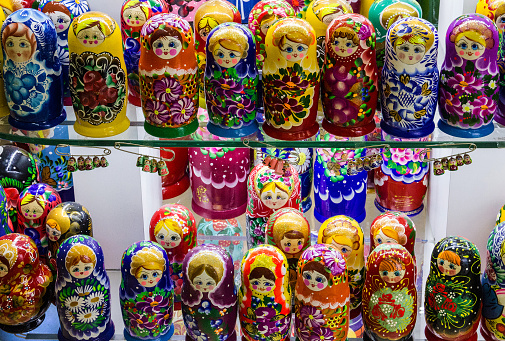 Traditional Russian souvenirs Matryoshka on shelfs in souvenir shop. lots of nesting dolls