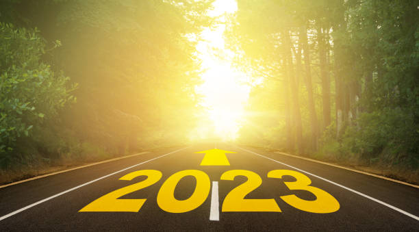 istock The word 2023 written on forest road 1400385313