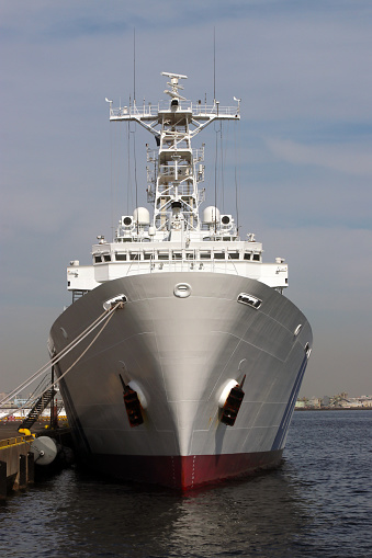 Front close up view of the Japan Coast Guard Patrol ship moored at the port of Yokohama. This photo shows a Japan Coast Guard patrol boat anchored in Yokohama Port on a clear day.