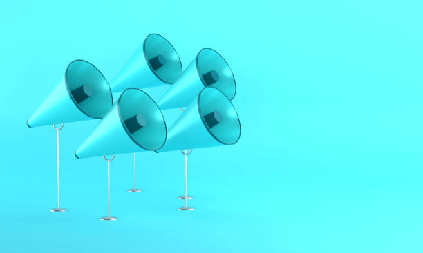 Blue megaphones stand on blue background. Communication concept.