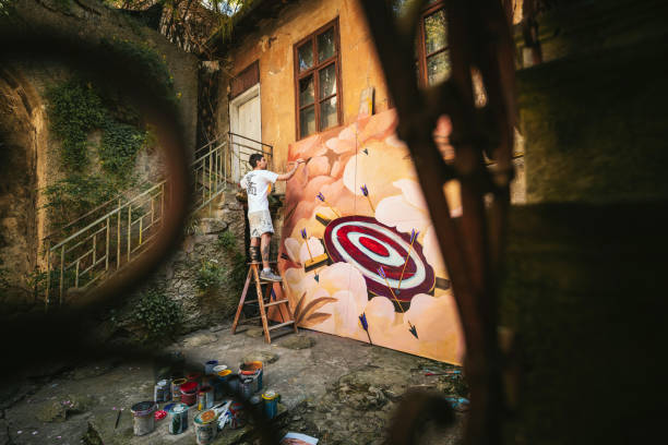 istock Male artist working on a big painting. 1400387309