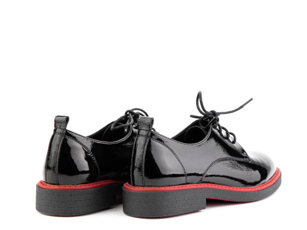 istock Women's oxford black leather shoes with red stripe isolated white background. Back side view. Fashion shoes. Photoshoot for shoe shop concept 1400389382