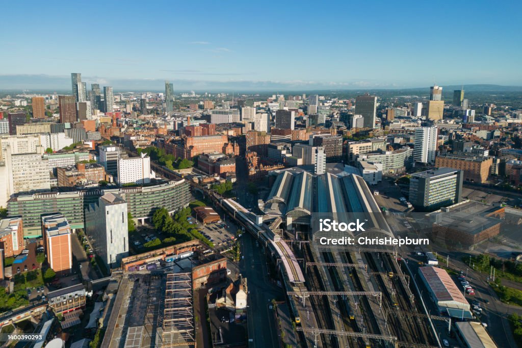 Aerial view of the city of Manchester, England, UK Wide angle aerial view over Manchester city centre, including Piccadilly Station and skyscrapers in the Deansgate area. Early morning sunlight. Manchester - England Stock Photo