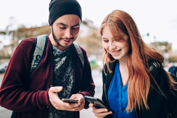 istock Young couple using cell phone at the city 1400390325