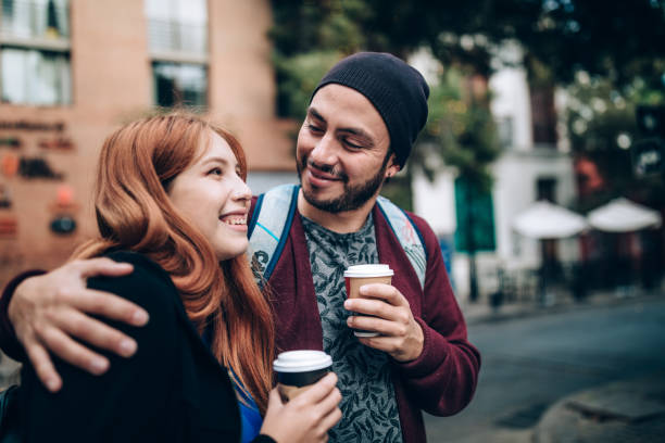 istock Young couple drinking coffee on the streets 1400390350