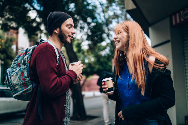 istock Young couple drinking coffee on the streets 1400390358