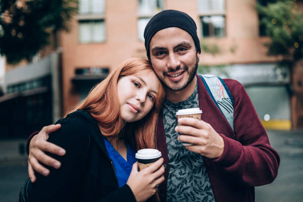 Young couple drinking coffee on the streets