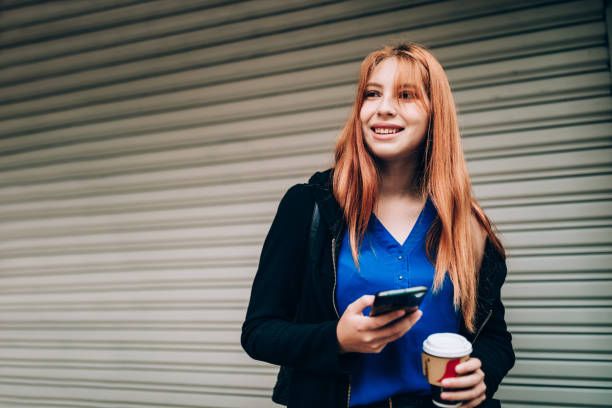 istock Young woman using cell phone 1400390377
