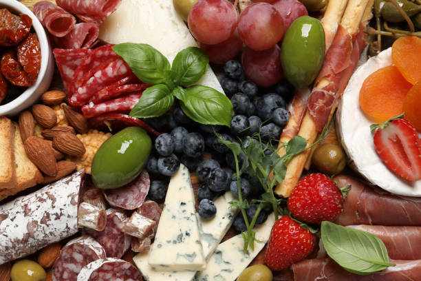 istock Set of different delicious appetizers as background, top view 1400390795