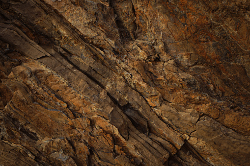 A macro image of ancient layers of sandstone, eroding