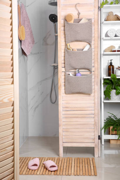 istock Wooden mat with slippers on floor in bathroom 1400392876