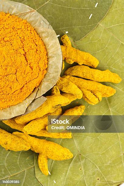 Turmeric Roots Next To Bowl Of Turmeric Powder Stock Photo - Download Image Now - Antibiotic, Beauty In Nature, Beauty Product