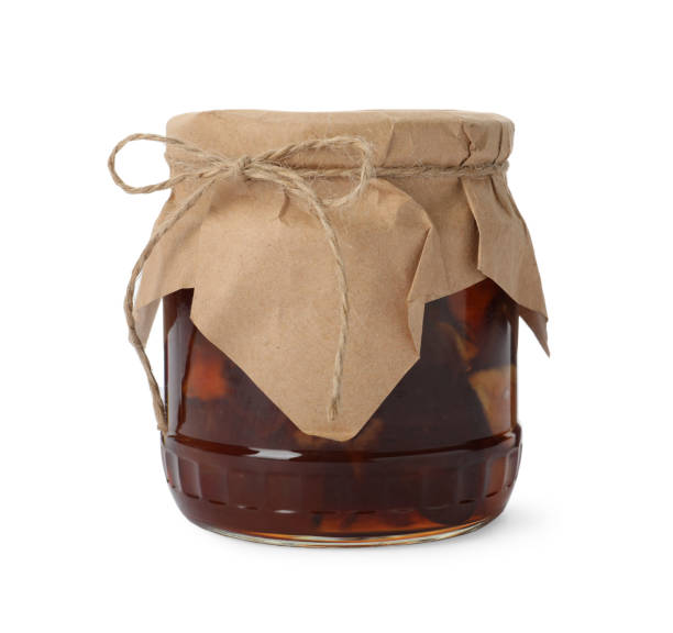 istock Tasty apple jam in glass jar isolated on white 1400393855