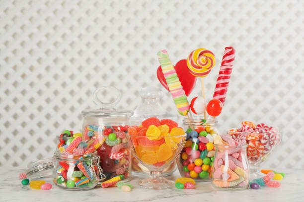 istock Jars with different delicious candies on white marble table 1400394103