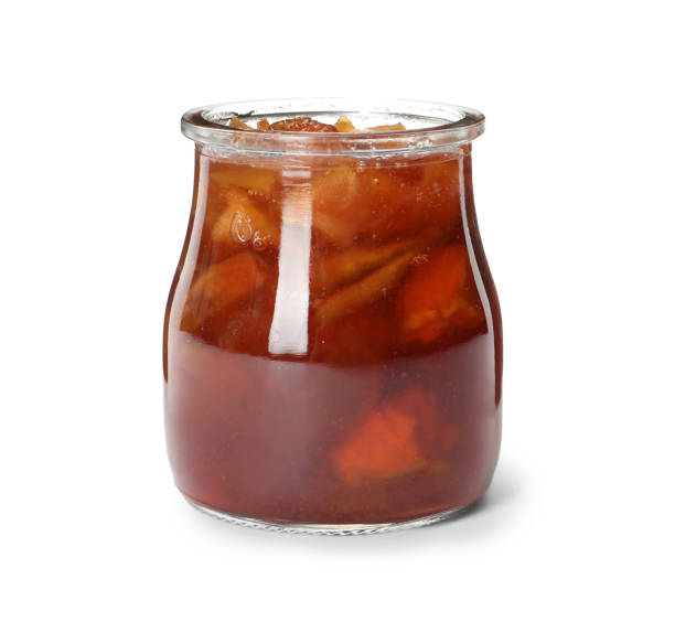 istock Tasty apple jam in glass jar isolated on white 1400394457