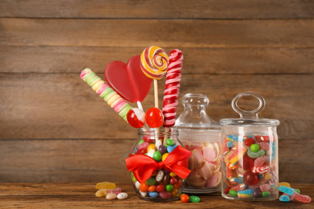 istock Jars with different delicious candies on wooden table 1400394566
