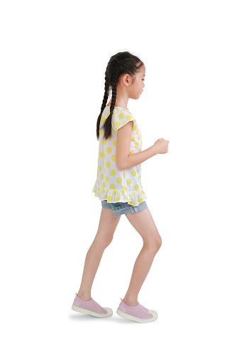 Asian little girl child walking gesture to beside isolated over white background