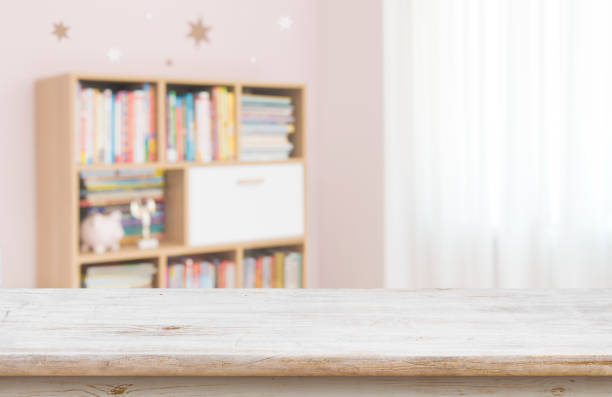 istock Empty desk for product display on defocused children room background 1400395577