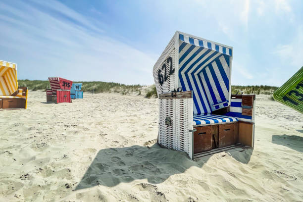 istock Hooded beach chair on sand 1400397926