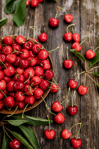 Sweet Cherries in bowl on dark stone concrete background